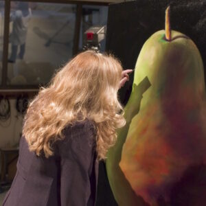 Woman painting a pear