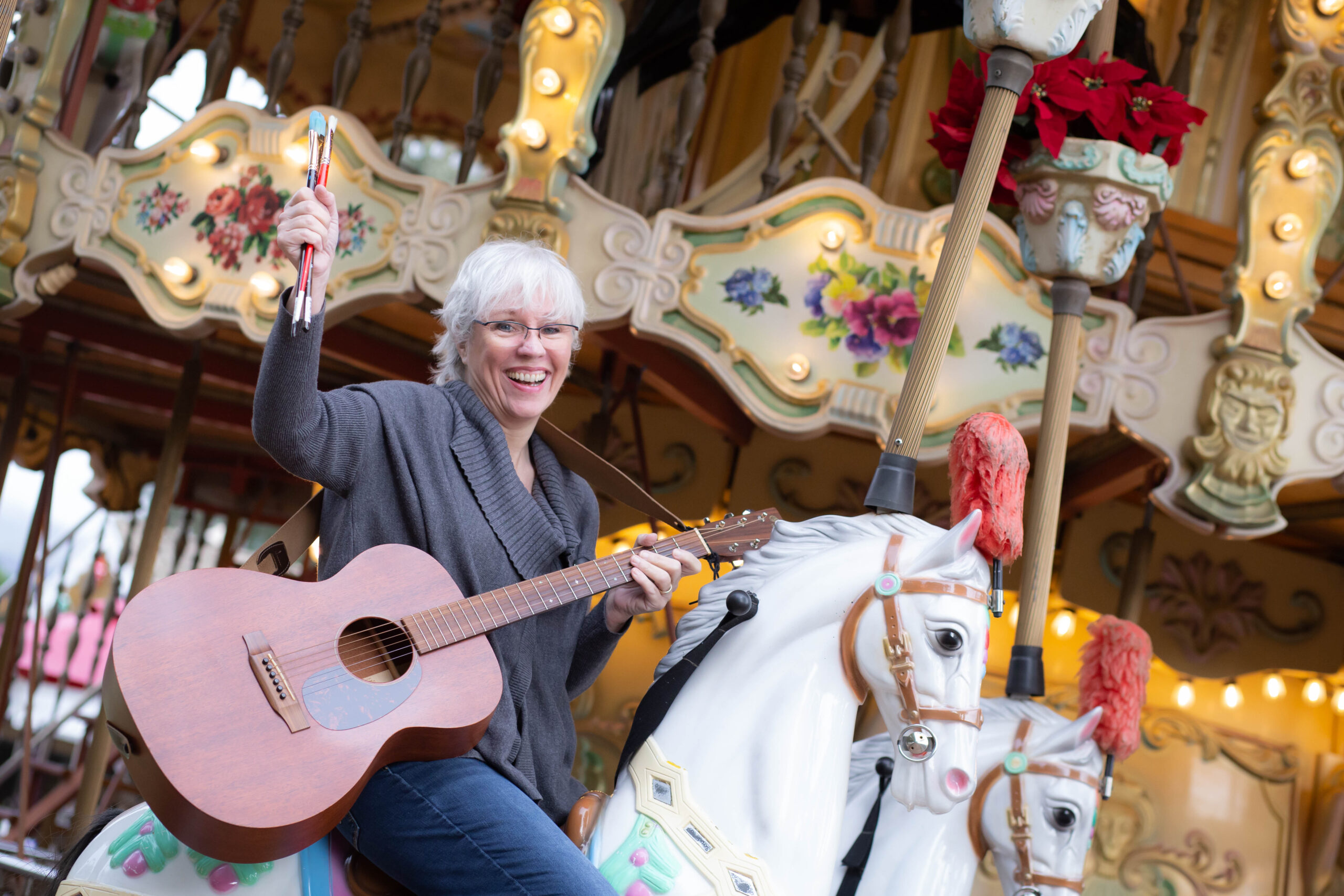Woman with guitar on merry go round
